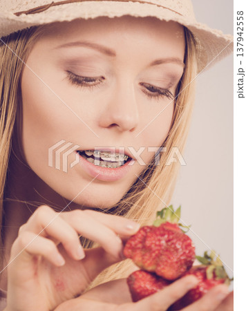 Young woman with fresh strawberries Young woman with fresh strawberries 137942558