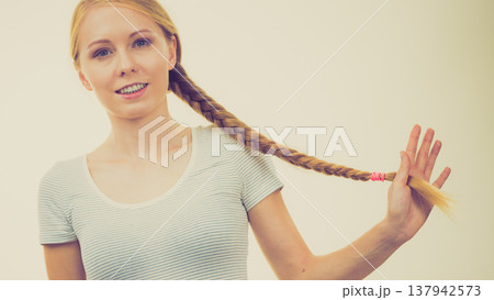 Blonde girl with long braid hair Blonde girl with long braid hair 137942573