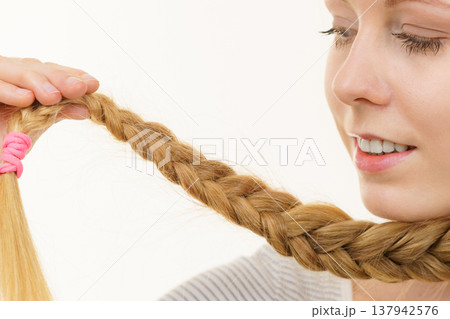 Blonde young woman with braid hair Blonde young woman with braid hair 137942576