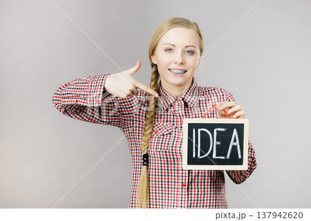 Happy positive woman holding idea sign 137942620