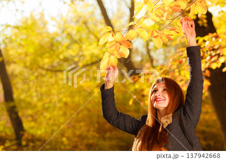 Young woman with branch Young woman with branch 137942668