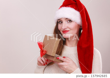 Woman opening gift box. Christmas time Woman opening gift box. Christmas time 137942685