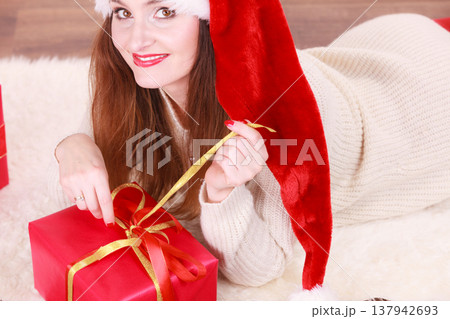 Woman opening gift box. Christmas time Woman opening gift box. Christmas time 137942693