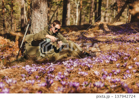 Hiker Taking Break in Early Spring Forest 137942724