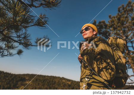 Male Hiker with Backpack Standing on Mountain Peak 137942732
