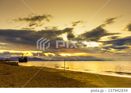 Rusty broken shipwreck on sea shore Rusty broken shipwreck on sea shore 137942834