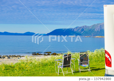 Camping on fjord. Camper and chairs 137942860