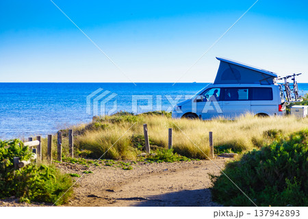 Camper van with roof top tent camp on beach Camper van with roof top tent camp on beach 137942893