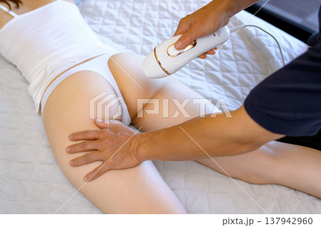 VIO脱毛をパートナー(彼氏、夫)に手伝ってもらう女性 うつ伏せ 家庭用脱毛器 VIO脱毛をパートナー(彼氏、夫)に手伝ってもらう女性 うつ伏せ 家庭用脱毛器 137942960