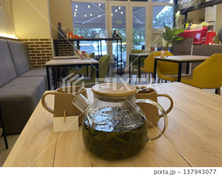 a tea pot and two glass cups of teaon a wooden table a tea pot and two glass cups of teaon a wooden table 137943077
