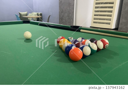 billiard balls are lying on a billiard table 137943162