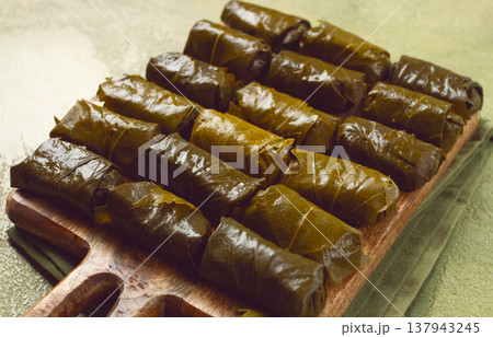 dolma, minced meat with rice, in grape leaves, minced meat rolls, on a chopping board, top view, no people, 137943245