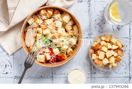 Caesar salad in a paper container, take it on the way, with sauce and croutons, on the table, snack, no people, Caesar salad in a paper container, take it on the way, with sauce and croutons, on the table, snack, no people, 137943266