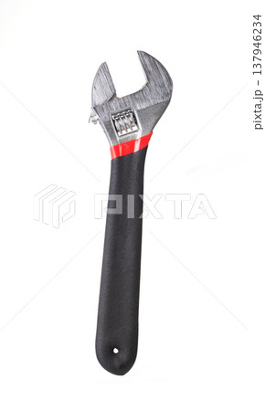 Adjustable wrench with black rubber handle isolated on white background. Metal spanner hand tool for repair 137946234