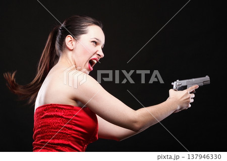 Sexy young woman - gun on black background Sexy young woman - gun on black background 137946330