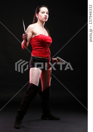 Sexy young woman - gun on black background Sexy young woman - gun on black background 137946332