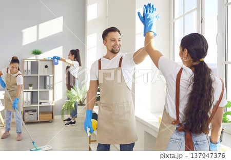 Cleaner Staff Giving High Five While Cleaning A Home Or Office Cleaner Staff Giving High Five While Cleaning A Home Or Office 137947376