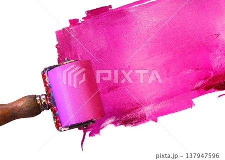 Closeup of a pink ink roller with a wooden handle applying a bold magenta layer of paint across a white background. Dynamic motion of the printing too Closeup of a pink ink roller with a wooden handle applying a bold magenta layer of paint across a white background. Dynamic motion of the printing too 137947596