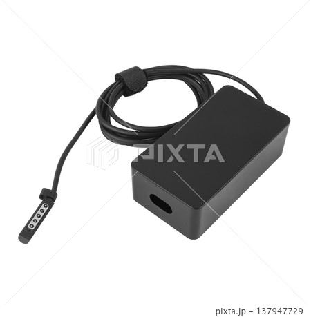 laptop power adapter, laptop spare part, on a white background, angled side view 137947729