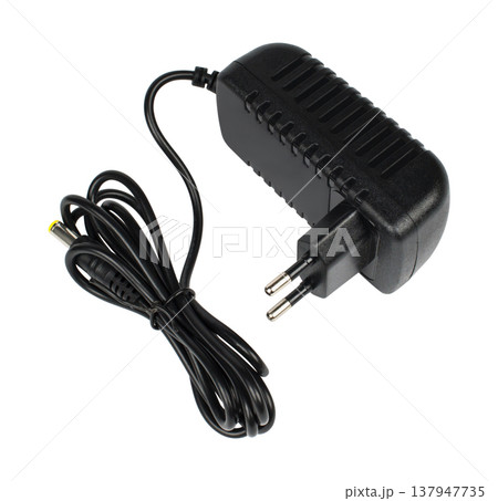 laptop power adapter, laptop spare part, on a white background, angled side view 137947735