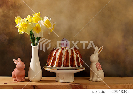 Easter celebration concept, Traditional Easter cake, Easter bunny figurines and spring daffodils in a vase on an elegant kitchen background, Easter dish ideas for home cooking, design template Easter celebration concept, Traditional Easter cake, Easter bunny figurines and spring daffodils in a vase on an elegant kitchen background, Easter dish ideas for home cooking, design template 137948303