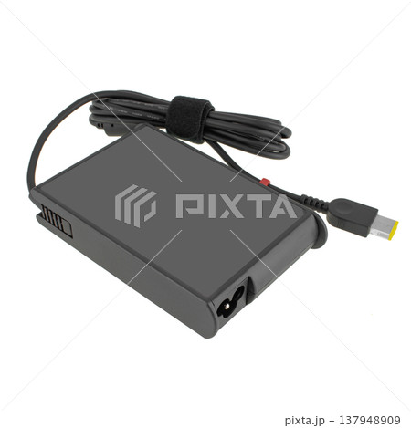 laptop power adapter, with a three-pin socket, on a white background laptop power adapter, with a three-pin socket, on a white background 137948909