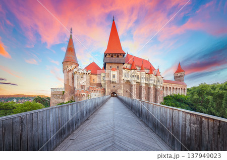 Breathtaking evening view of Hunyad Castle (Corvin's Castle) with wooden bridge at sunset . Breathtaking evening view of Hunyad Castle (Corvin's Castle) with wooden bridge at sunset . 137949023