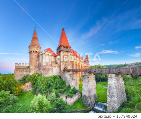 Breathtaking evening view of Hunyad Castle (Corvin's Castle) with wooden bridge at sunset . Breathtaking evening view of Hunyad Castle (Corvin's Castle) with wooden bridge at sunset . 137949024