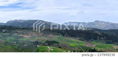 Panoramic view of surrounding landscapes and mountains from scenic elevated viewpoint in Ronda, Spain. Panoramic view of surrounding landscapes and mountains from scenic elevated viewpoint in Ronda, Spain. 137949230