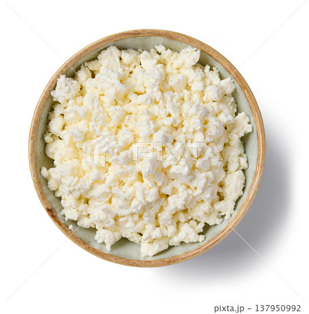 Fresh cottage cheese in ceramic bowl isolated on white background, top view Fresh cottage cheese in ceramic bowl isolated on white background, top view 137950992