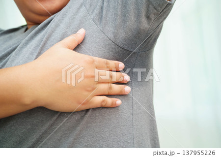 Sweaty underarms, Asian woman with sweat on clothes under armpit. 137955226