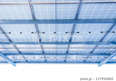 Aerial view of solar panels installed as shade canopy over parking lot with parked cars to generate electricity, photovoltaic technology 137956868