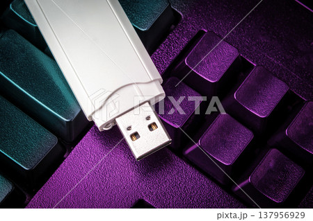 USB flash drive lying on black keyboard. Virtual memory storage with USB output 137956929