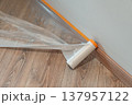 Protective Plastic Sheeting on Wooden Floor 137957122