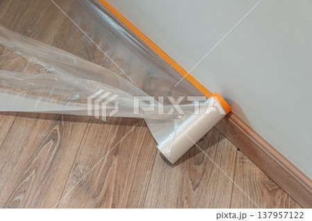 Protective Plastic Sheeting on Wooden Floor Protective Plastic Sheeting on Wooden Floor 137957122