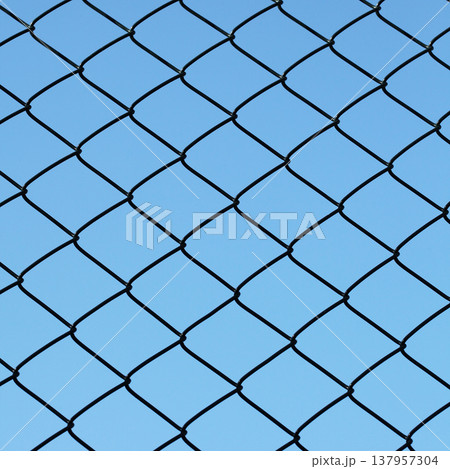 Chain-link fence with blue sky 137957304