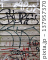 A wooden wall with graffiti 137957370