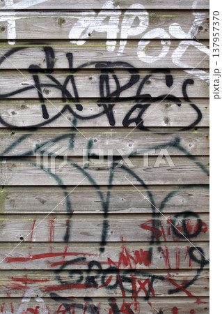 A wooden wall with graffiti 137957370