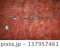 A crack in a red wall 137957461