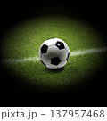 Soccer ball placed exactly on the white line on green grass soccer field, close-up view. 137957468