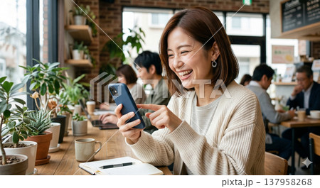 楽しそうにスマホをタップする女性 137958268