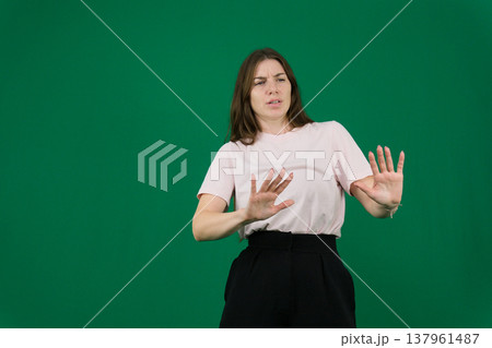 different emotions of a young girl on a green background chromakey beautiful facial features real people pink T-shirt white skinned European. black flared wide leg trousers different emotions of a young girl on a green background chromakey beautiful facial features real people pink T-shirt white skinned European. black flared wide leg trousers 137961487