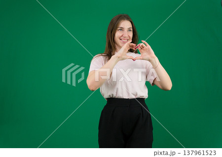 different emotions of a young girl on a green background chromakey beautiful facial features real people pink T-shirt white skinned European. black flared wide leg trousers different emotions of a young girl on a green background chromakey beautiful facial features real people pink T-shirt white skinned European. black flared wide leg trousers 137961523