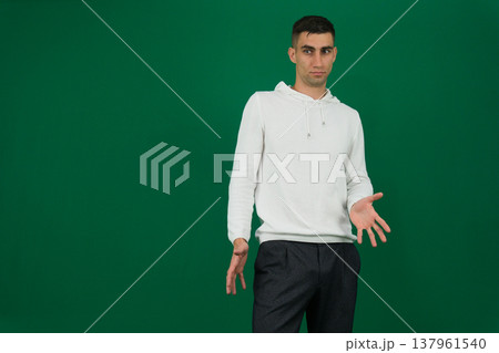 emotions of a handsome man guy on a green background chromakey close-up dark hair young man emotions of a handsome man guy on a green background chromakey close-up dark hair young man 137961540