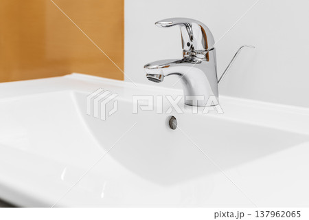 Chrome bathroom sink faucet and white washbasin 137962065