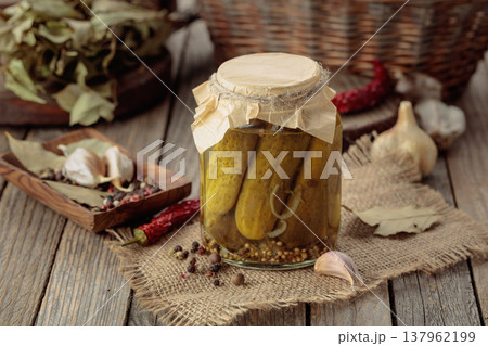 Homemade canned gherkins on a rustic wooden background. 137962199