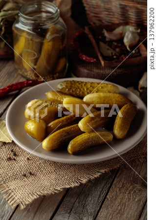 Homemade canned gherkins on a rustic wooden background. 137962200
