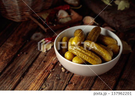 Homemade canned gherkins on a rustic wooden background. 137962201