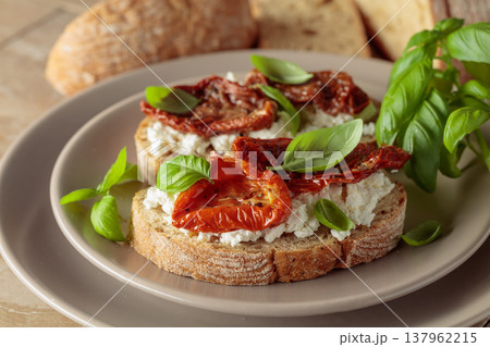 Ciabatta with sun dried tomatoes in olive oil, creamy cheese, and basil. Ciabatta with sun dried tomatoes in olive oil, creamy cheese, and basil. 137962215