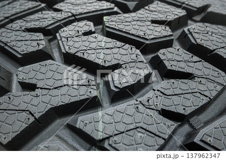 Black tire tread texture background with detailed rubber pattern. Black tire tread texture background with detailed rubber pattern. 137962347